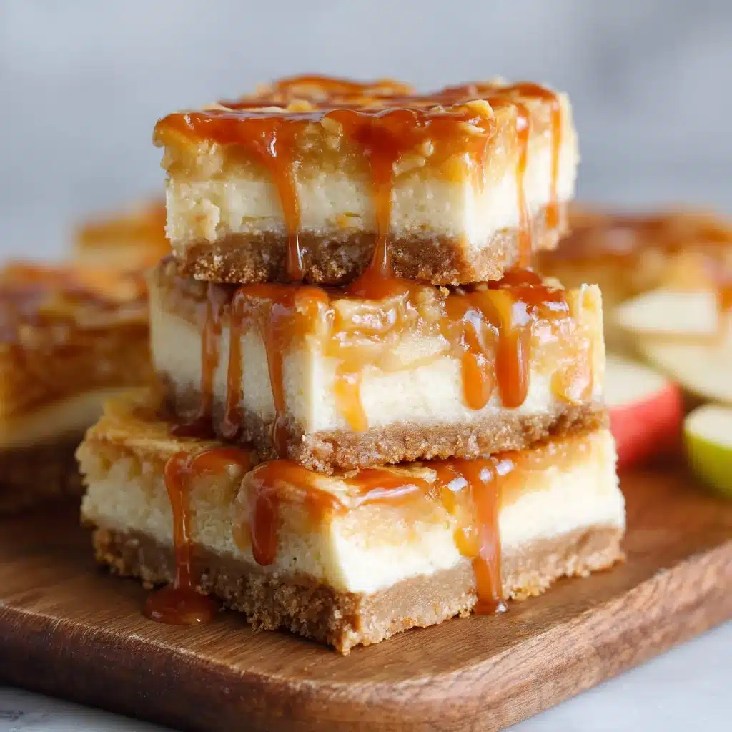Delicious Caramel Apple Cheesecake Bars topped with caramel drizzle and apple slices.