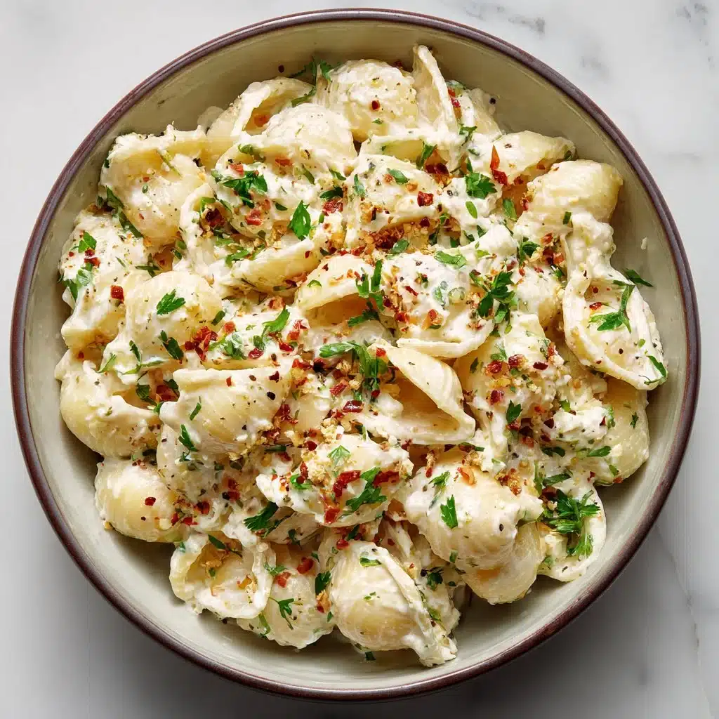 Creamy ricotta pasta dish garnished with herbs and cheese