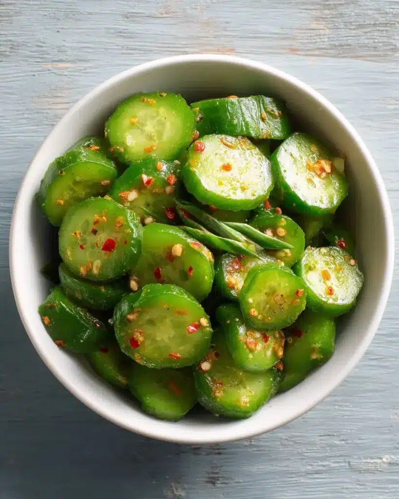 Spicy cucumber salad with fresh vegetables and herbs in a bowl